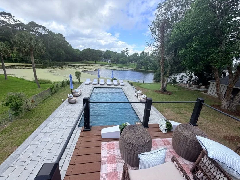 Elevated deck view of completed pool and paver patio