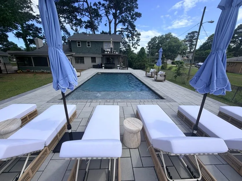 Poolside paver patio with lounge seating