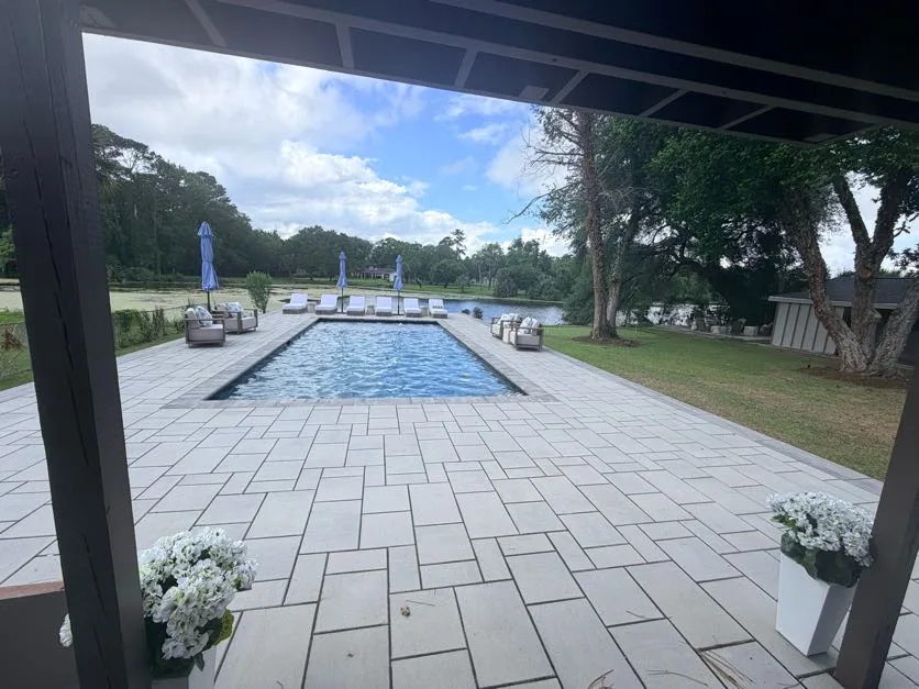 Pool and patio viewed through covered pergola