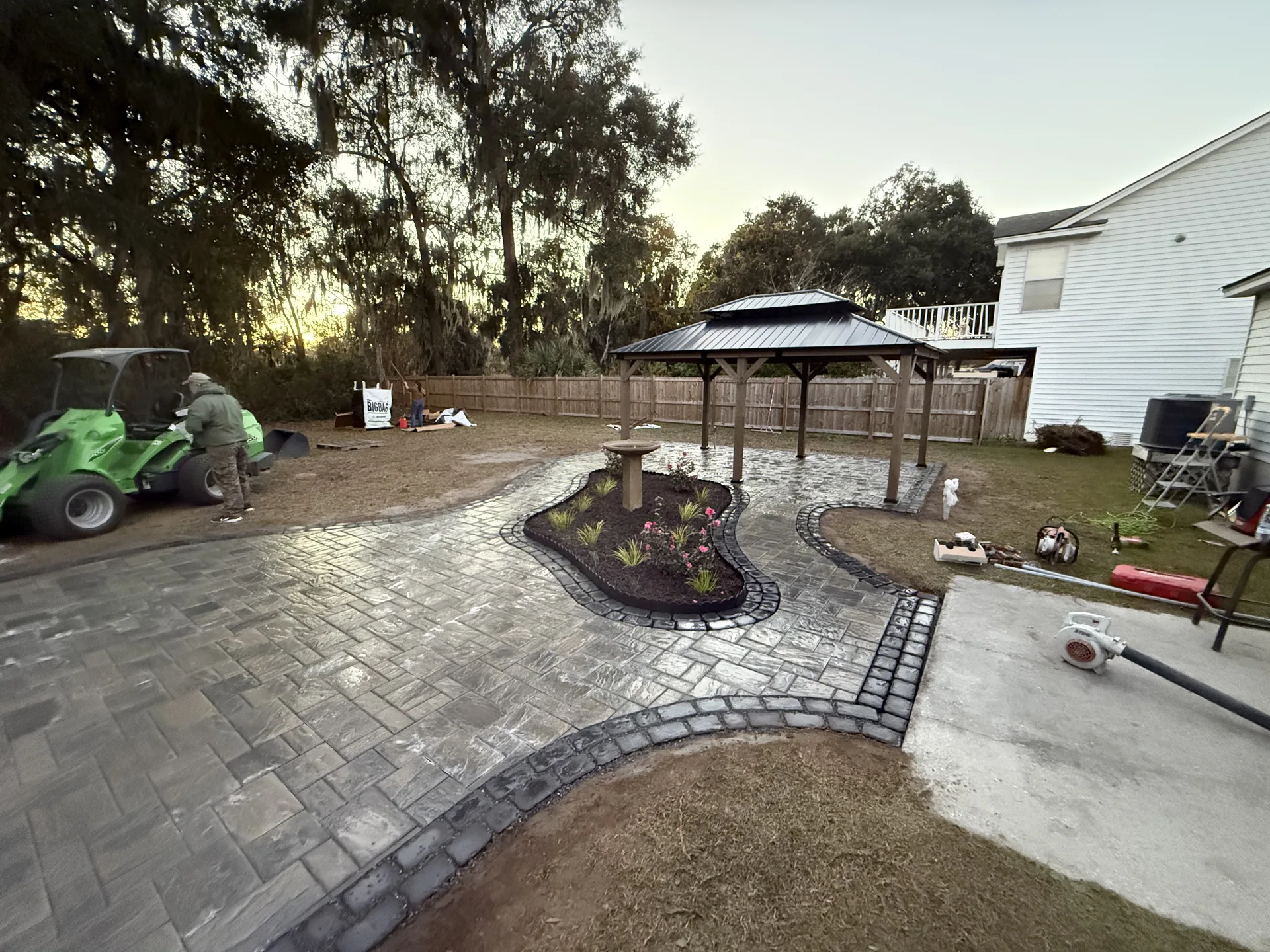 Large paver patio with gazebo and landscaping